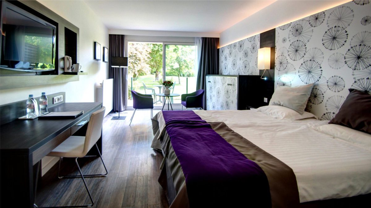 This ground floor bedroom at Hotel du Parc, Hardelot opens up to the grounds