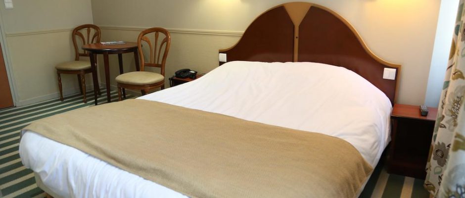 A comfortable double bedroom at Hotel du Centre, Wimereux, Northern France