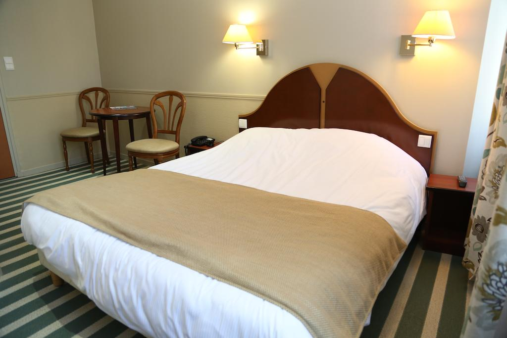 A comfortable double bedroom at Hotel du Centre, Wimereux, Northern France