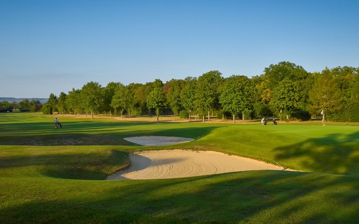 Golfer approaching a green at Golf de Château de Chailly