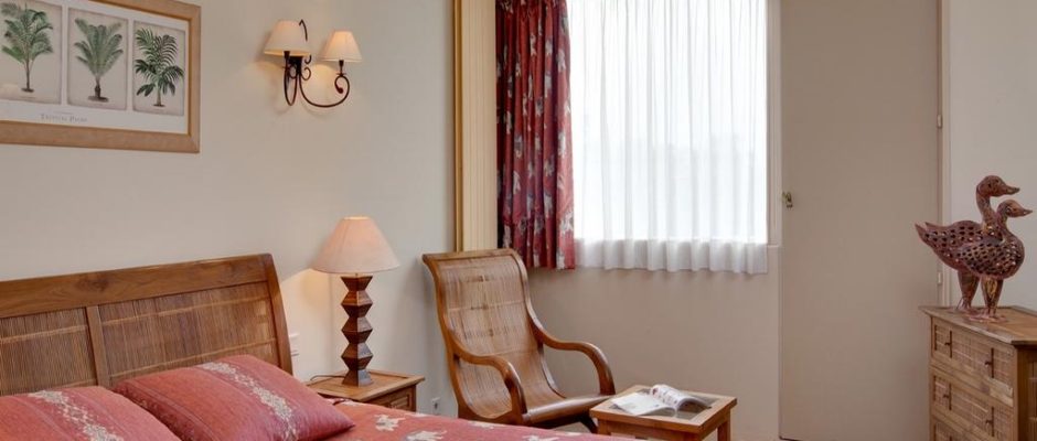 A comfortable double bedroom at Grand Hotel de Solesmes, Loire, France