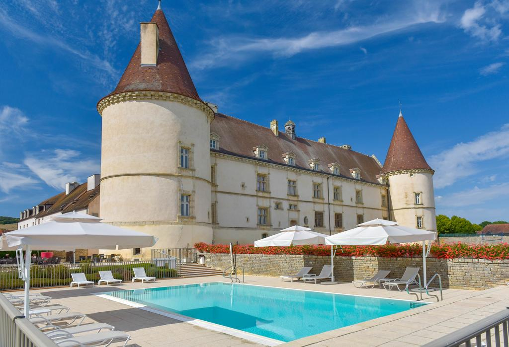 Château de Chailly exterior with turrets and outdoor pool
