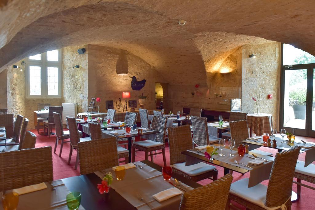 Vaulted clubhouse restaurant at Château de Chailly with red chairs