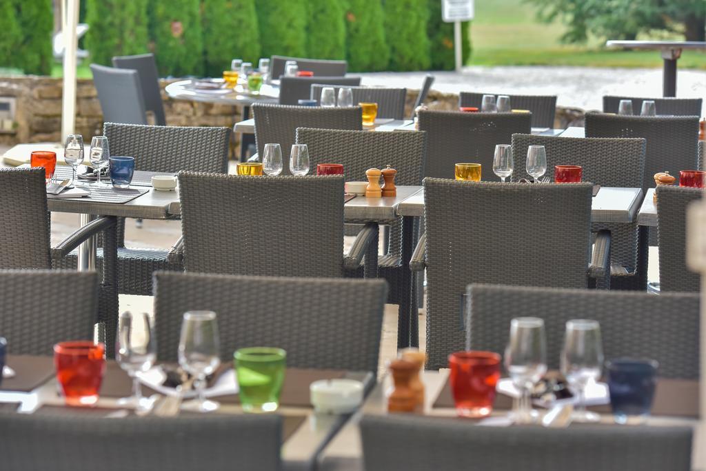 Outdoor dining terrace at Château de Chailly set with glasses