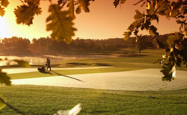 Le Château course at Terre Blanche with a greenkeeping mower near a bunker