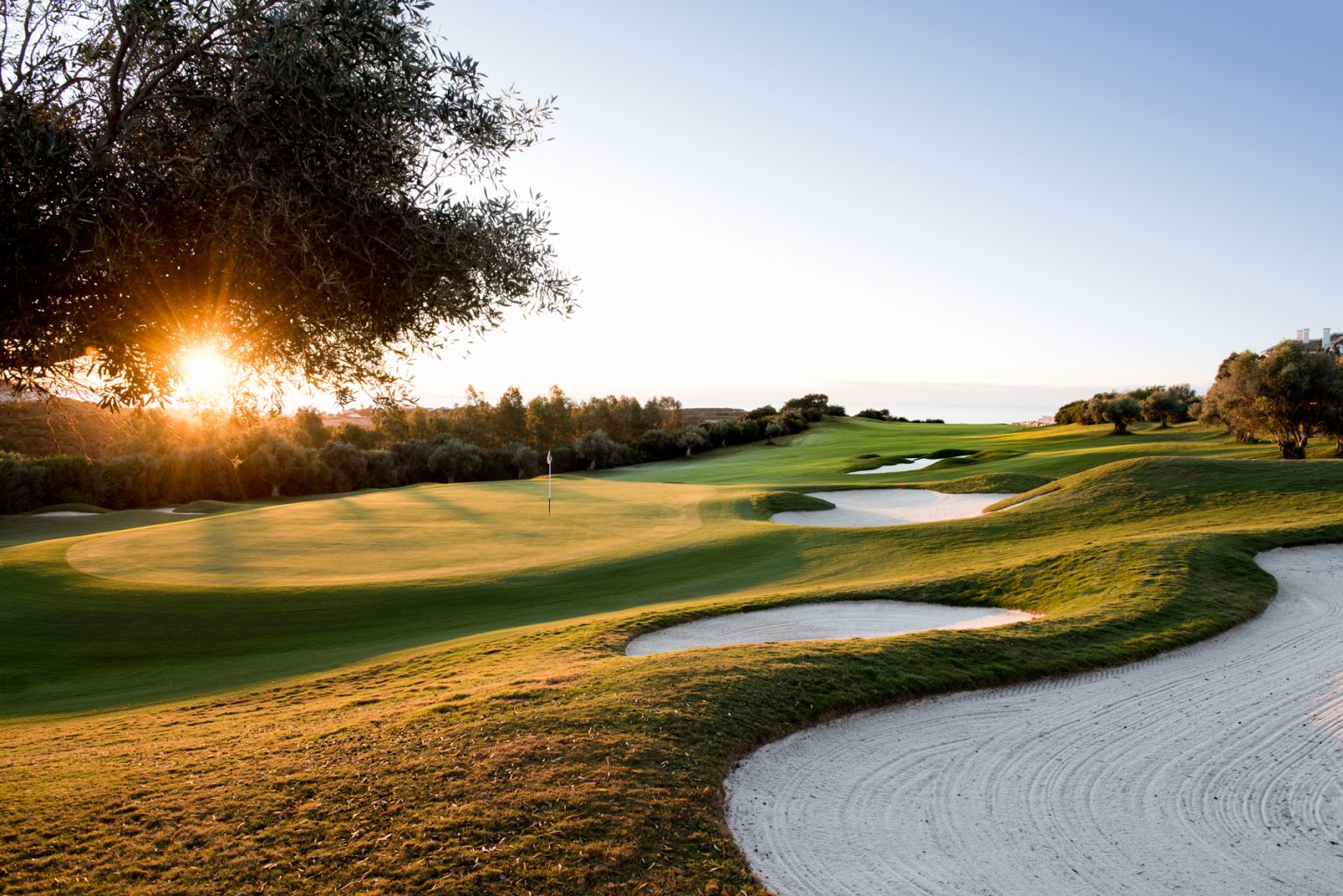 Sunrise over the 18th hole at Finca Cortesin golf course, Costa del Sol