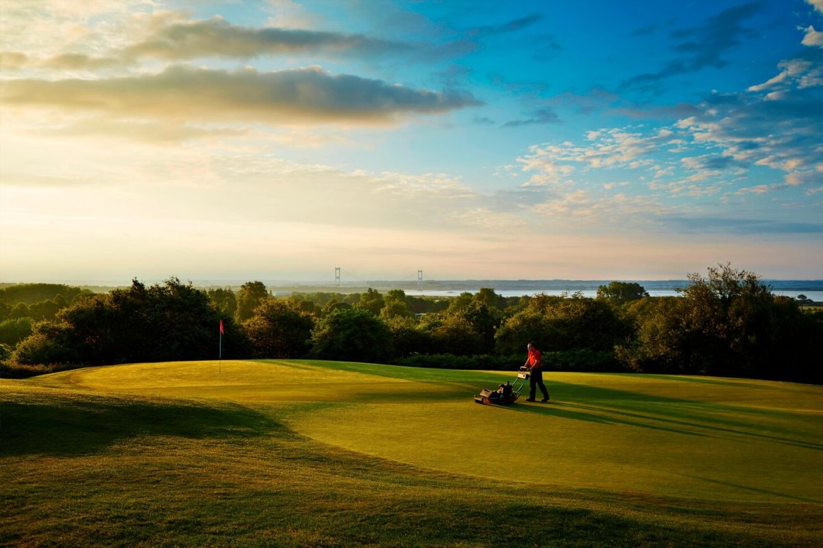 Mowing the fifth green at St Pierre Old course, Chepstow, England