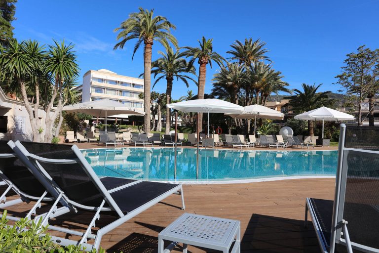 Outdoor pool and palm trees at Son Caliu Spa Oasis Hotel, Mallorca
