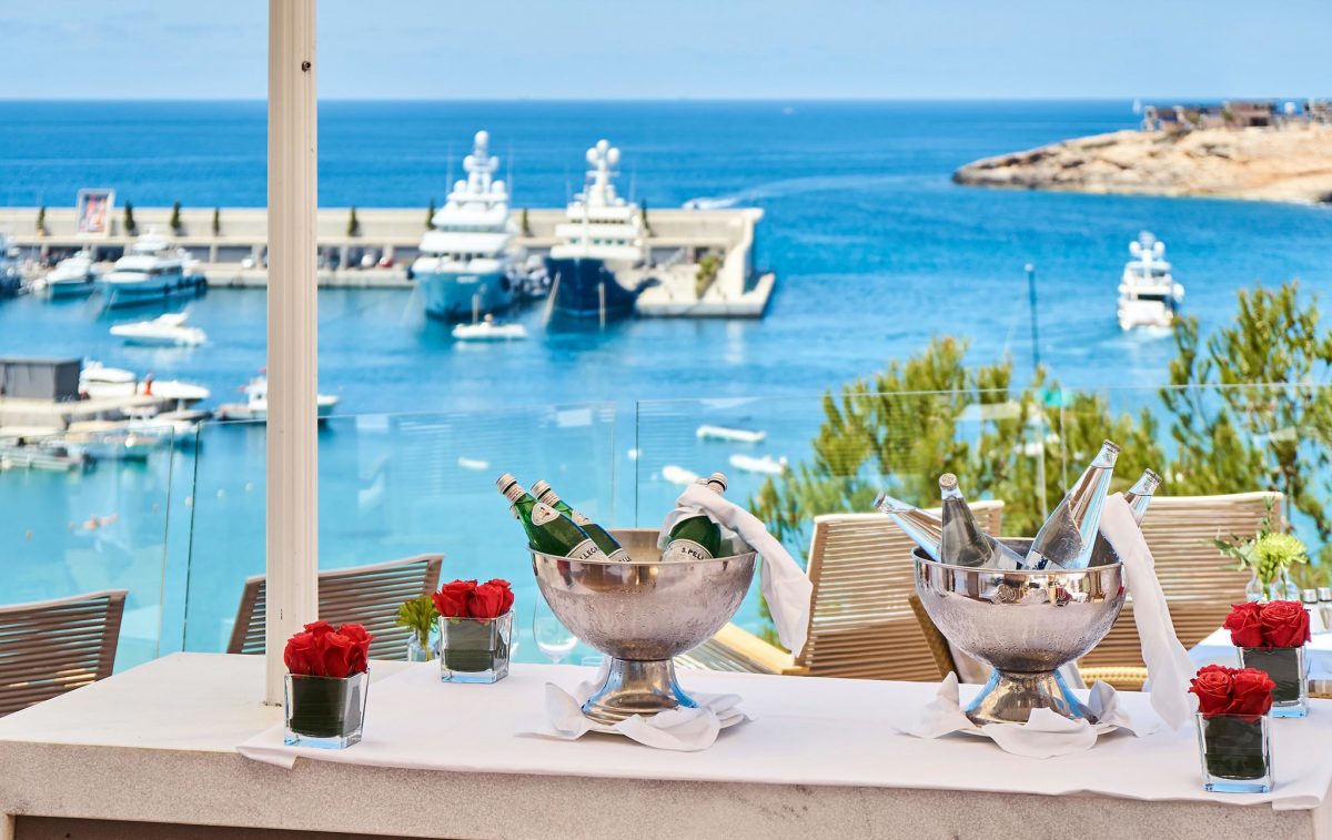Enjoy drinks on the terrace overlooking the yachts at Pure Salt Port Adriano Calvia