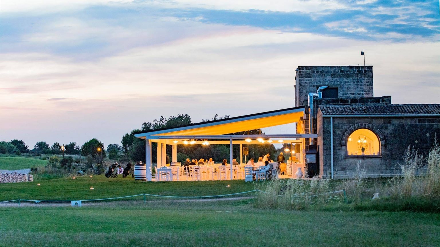 Evening dining on the terrace at Acaya Golf Resort, overlooking the golf course