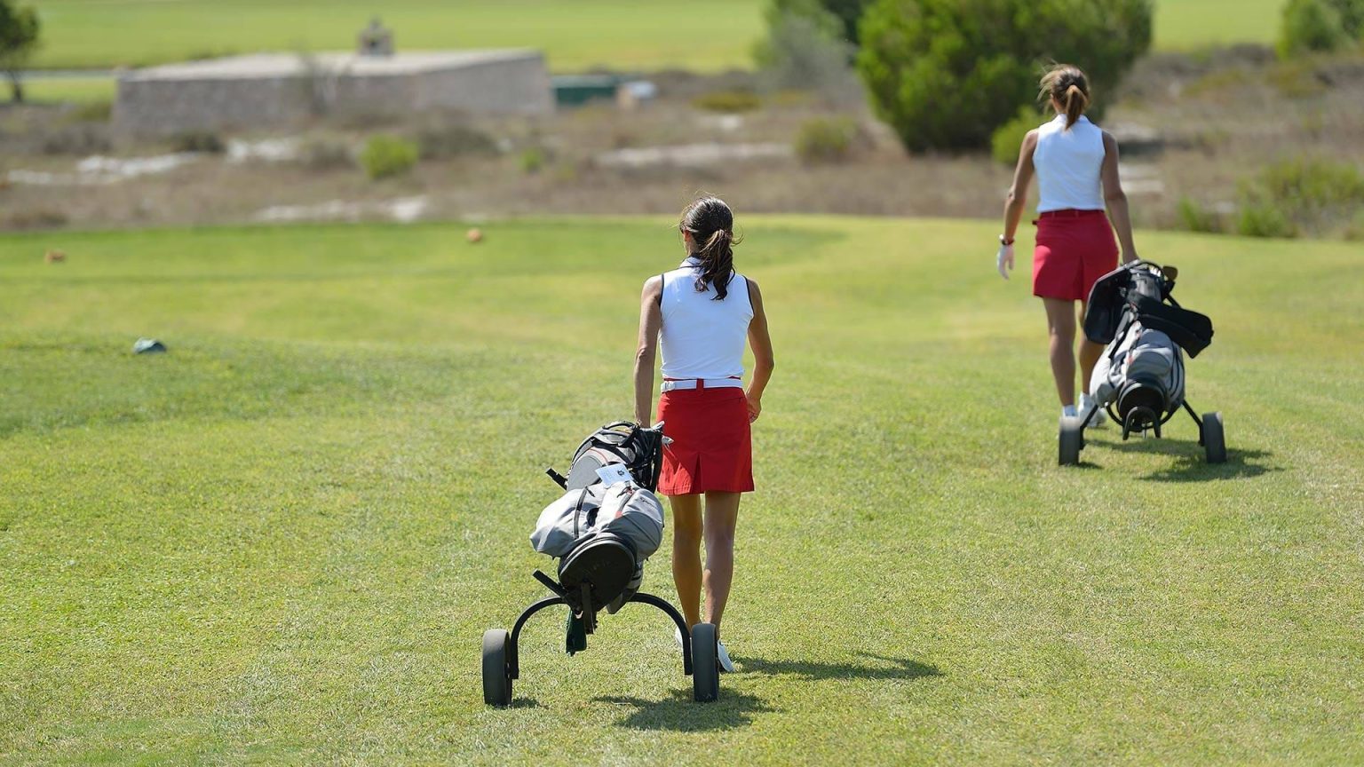 Golfers walking the fairway at Acaya Golf Club, Salento