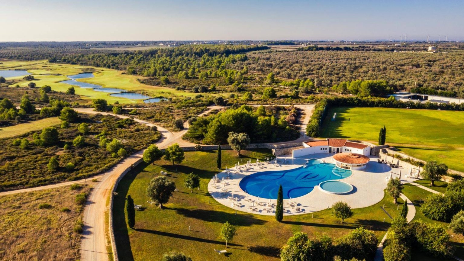 Aerial view of Acaya Golf Resort with its pool, gardens and surrounding Puglian countryside