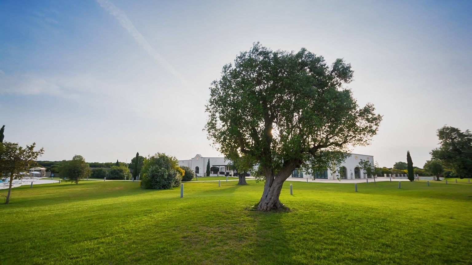 Landscaped lawns and the clubhouse at Acaya Golf Resort, Salento