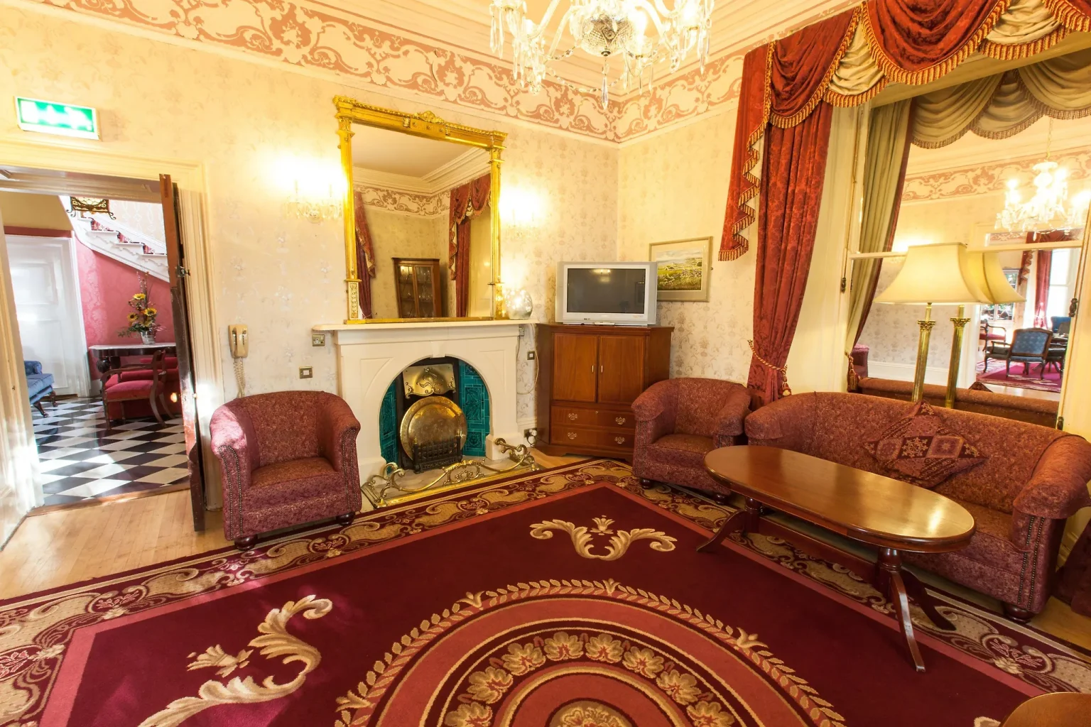 The period lobby lounge at The Ardilaun Hotel, with red carpet and antique furniture