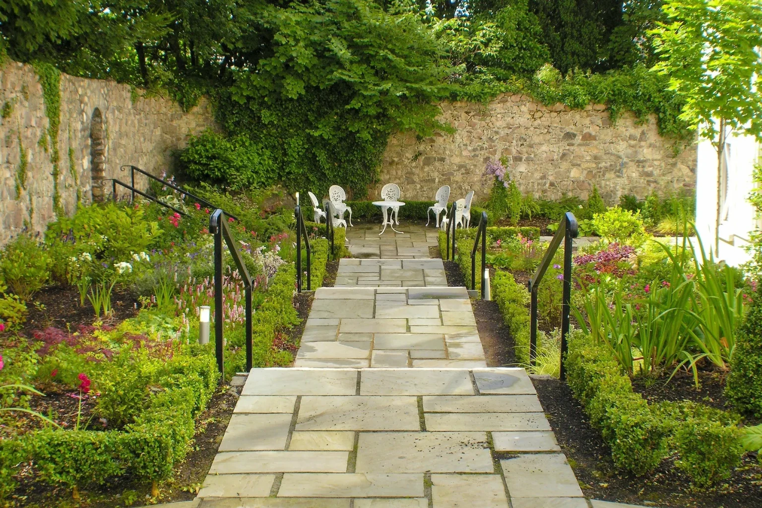 A stone path through the walled garden grounds at The Ardilaun Hotel