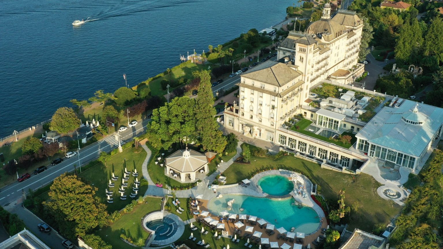 Aerial view of Grand Hotel des Iles Borromees from Lake Maggiore, showing the park, pools and lakefront