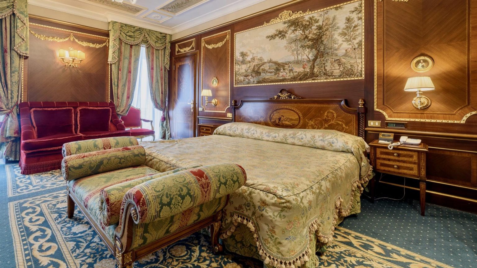 The Imperial Suite at Grand Hotel des Iles Borromees, with antique tapestry and an ornate bed