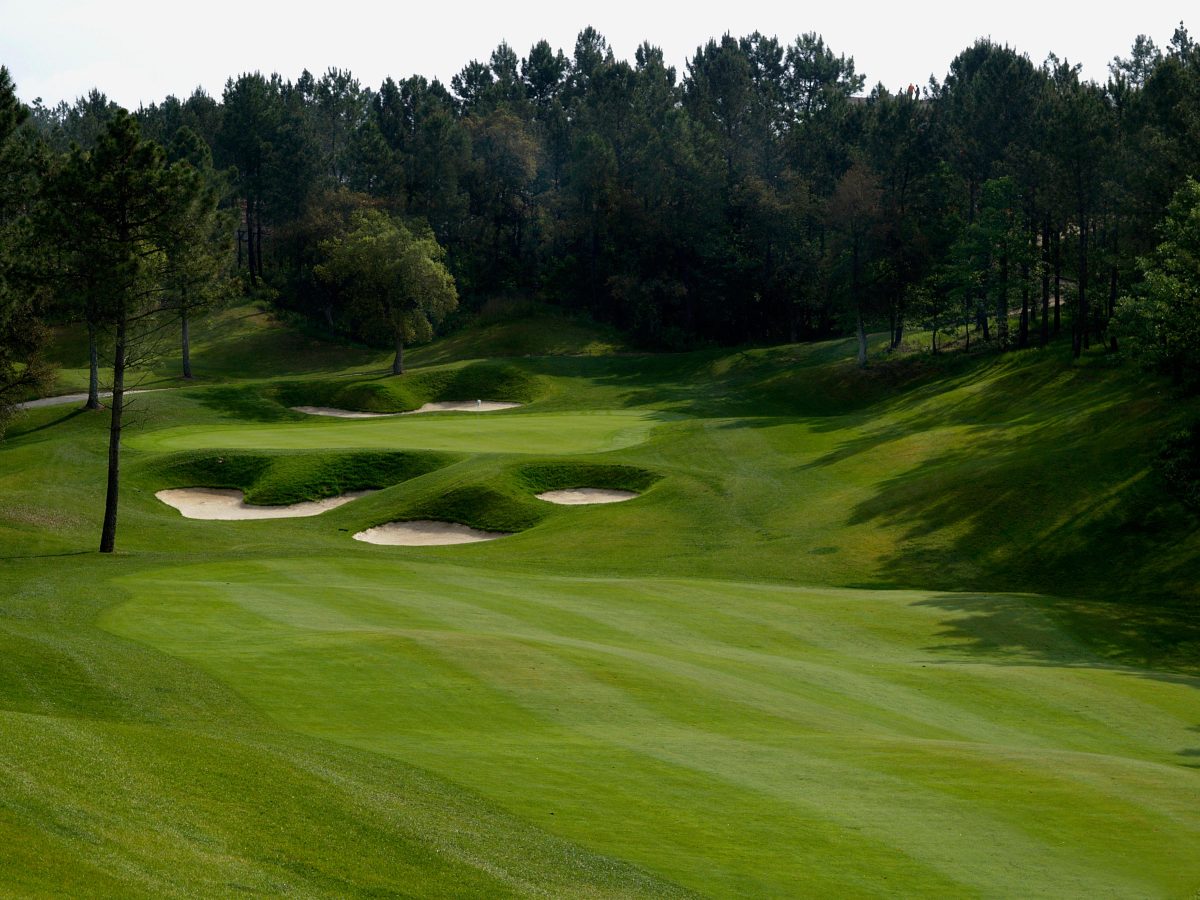 Elevated green surrounded by bunkers at PGA Catalunya Golf Resort, Costa Brava, Spain
