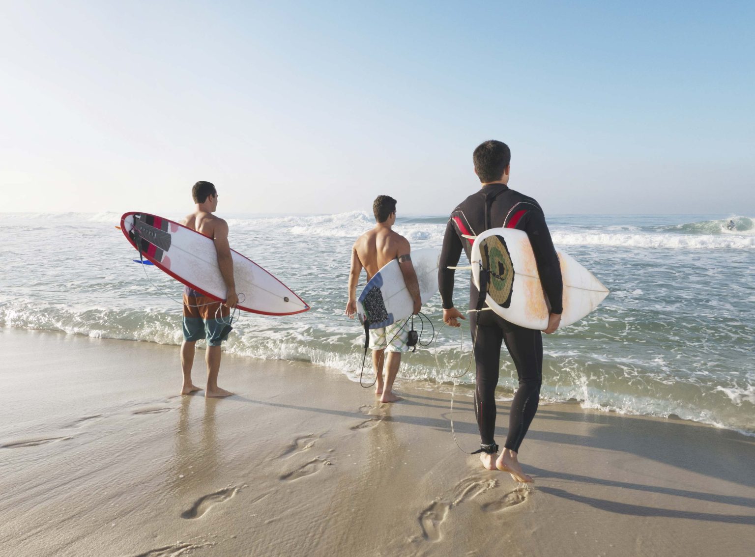 Surfers walking on Saunton Sands beach below the hotel