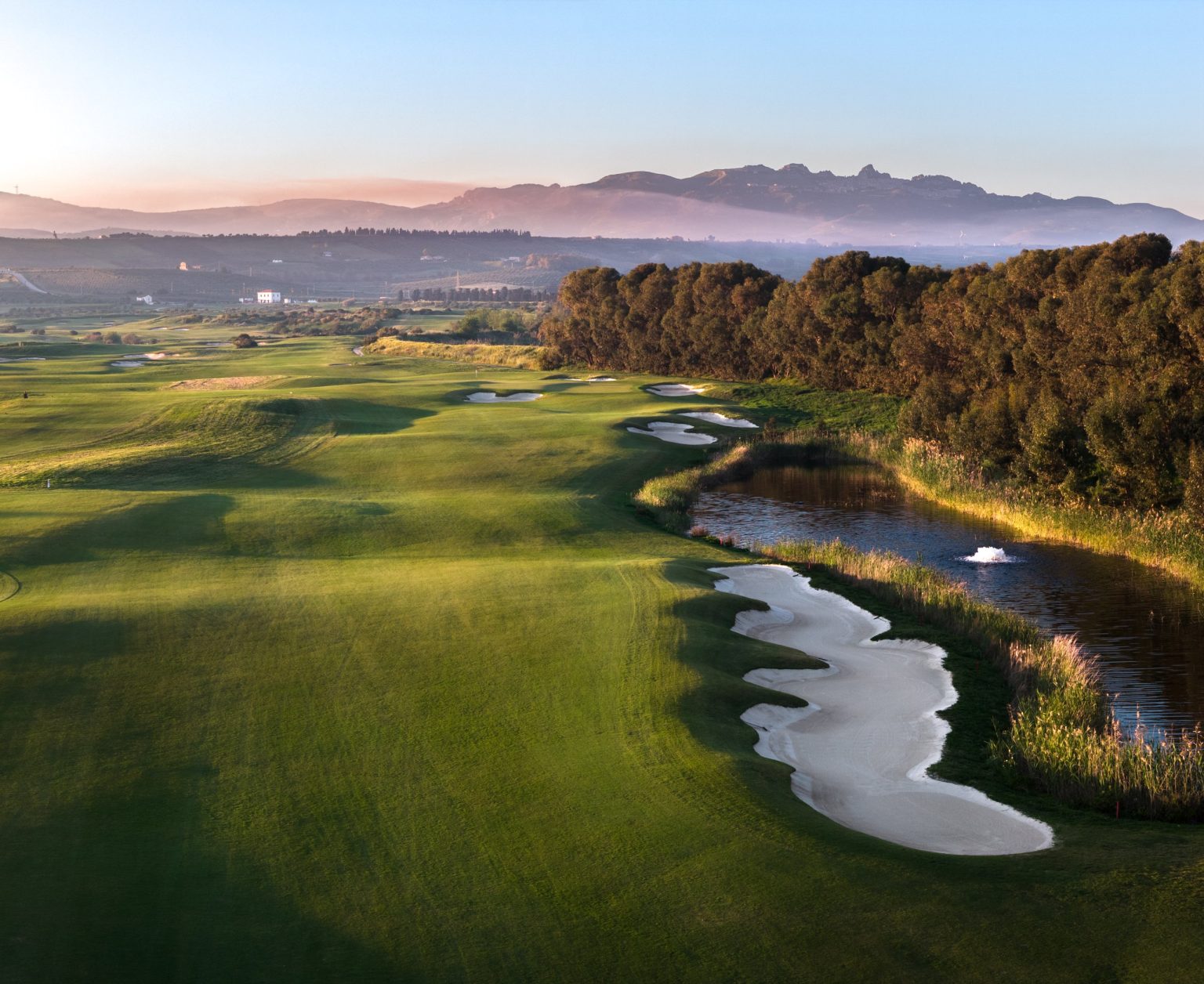 Aerial view of a fairway and water hazard on the golf course at Verdura, Sicily