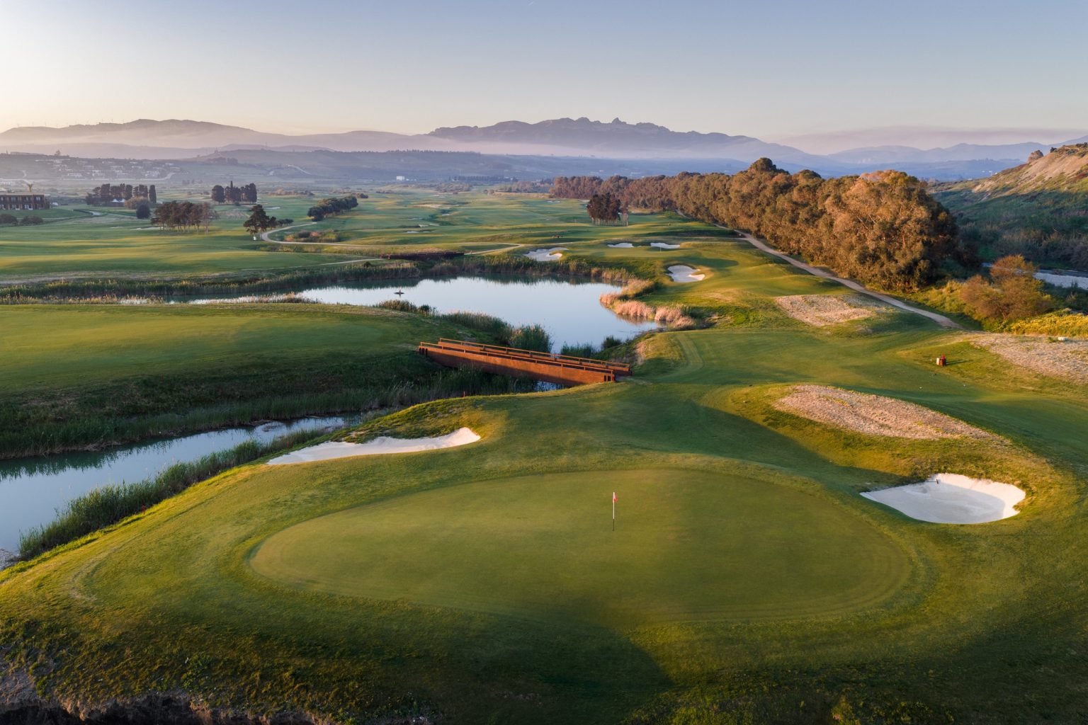 Aerial view of a green and water hazard on the Verdura golf course