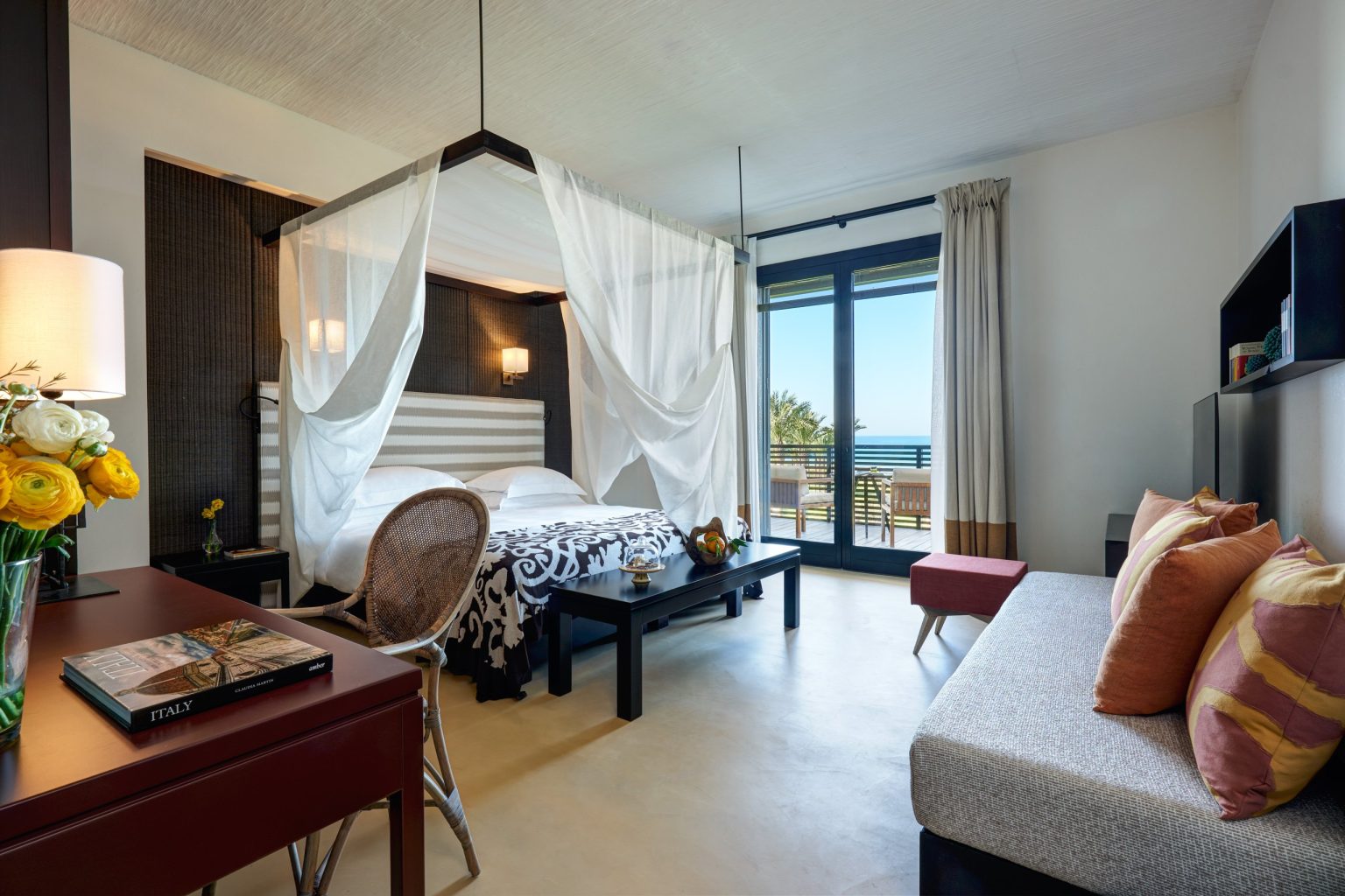 A deluxe room with a canopy bed at Verdura Resort, Sicily