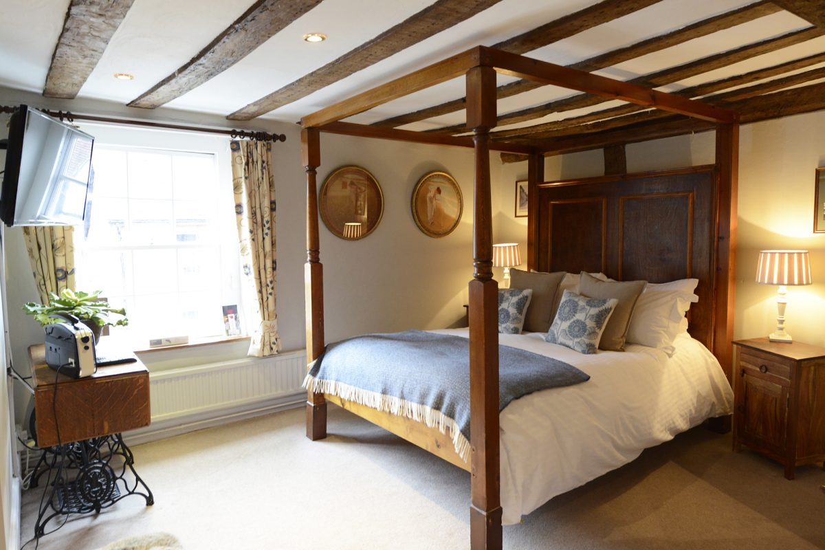 Timber lined bedroom at The Griffin Inn, Fletching, England