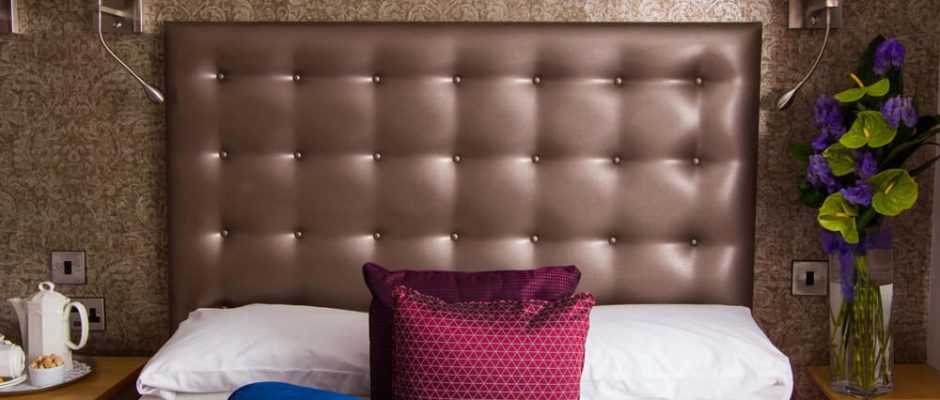 A comfortable bedroom at The Cooden Beach Hotel, Bexhill-on-Sea, England