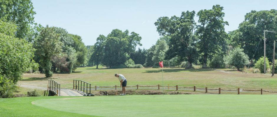 Golfer putting at Bramshaw Golf Club, Hampshire. England