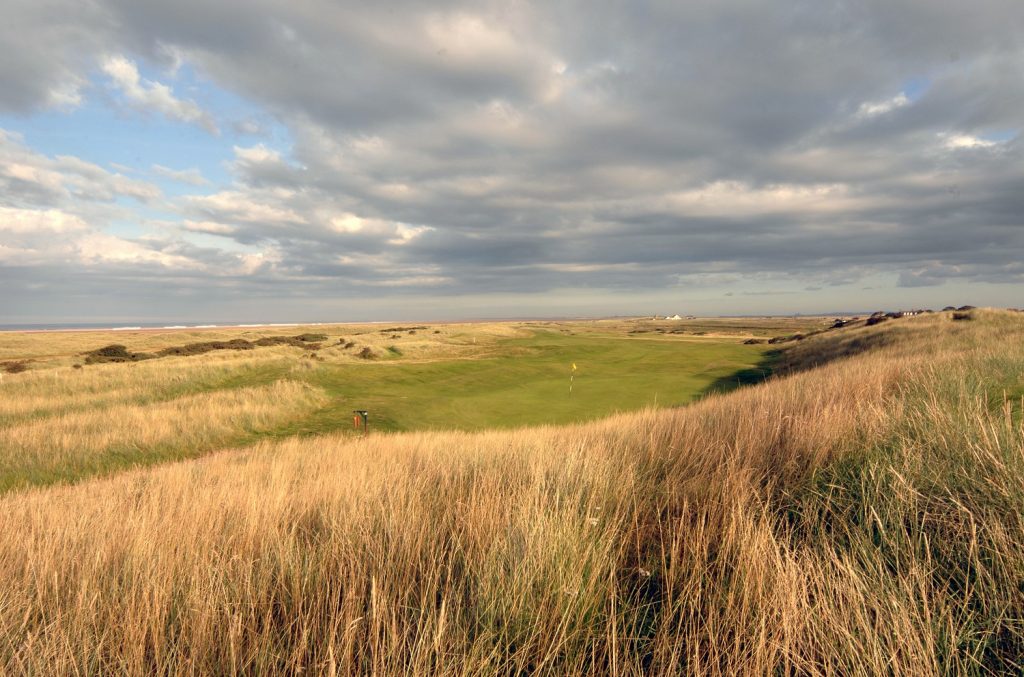 Deep rough surrounds the green at the 14th hole at Goswick Golf Club