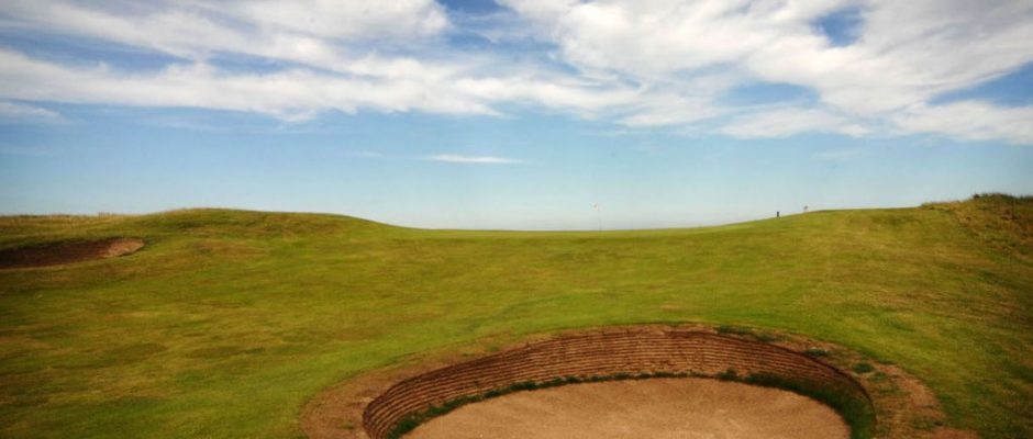 A pot bunker on the first hole at Goswick Golf Club, Northumberland, England