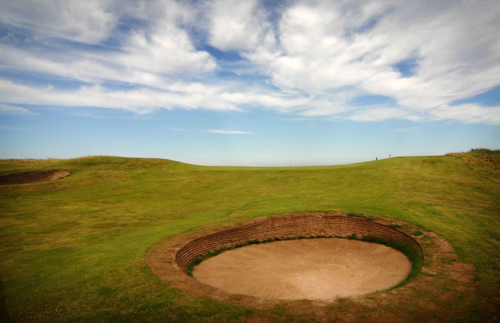 A pot bunker on the first hole at Goswick Golf Club, Northumberland, England