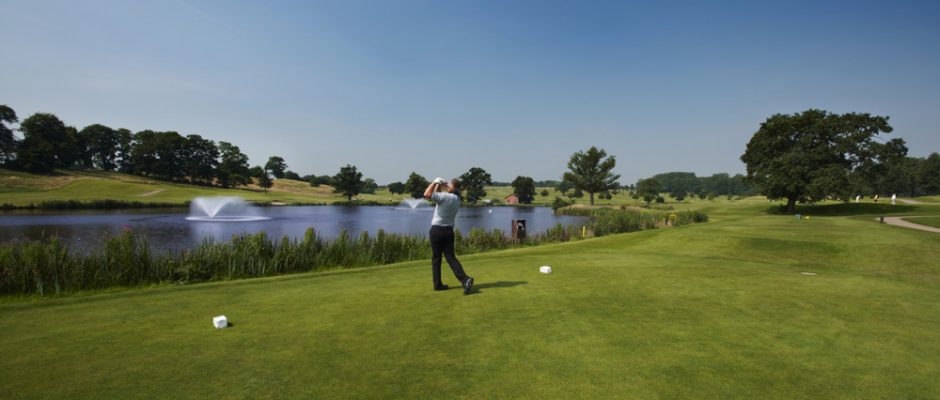 Tee off over the water on the 8th at the King's Course The Warwickshire Golf and Country Club, England