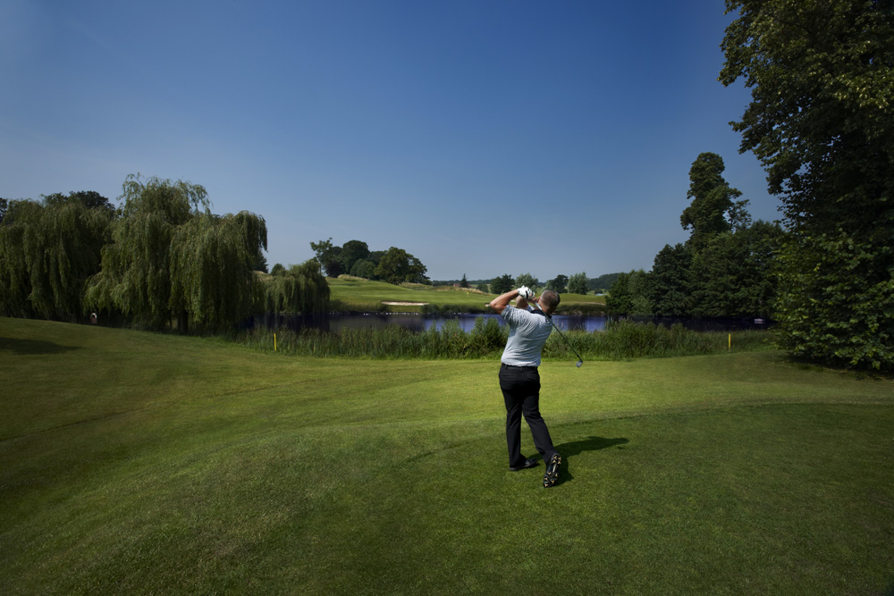 Driving over the water on the King's Course,The Warwickshire Golf Club