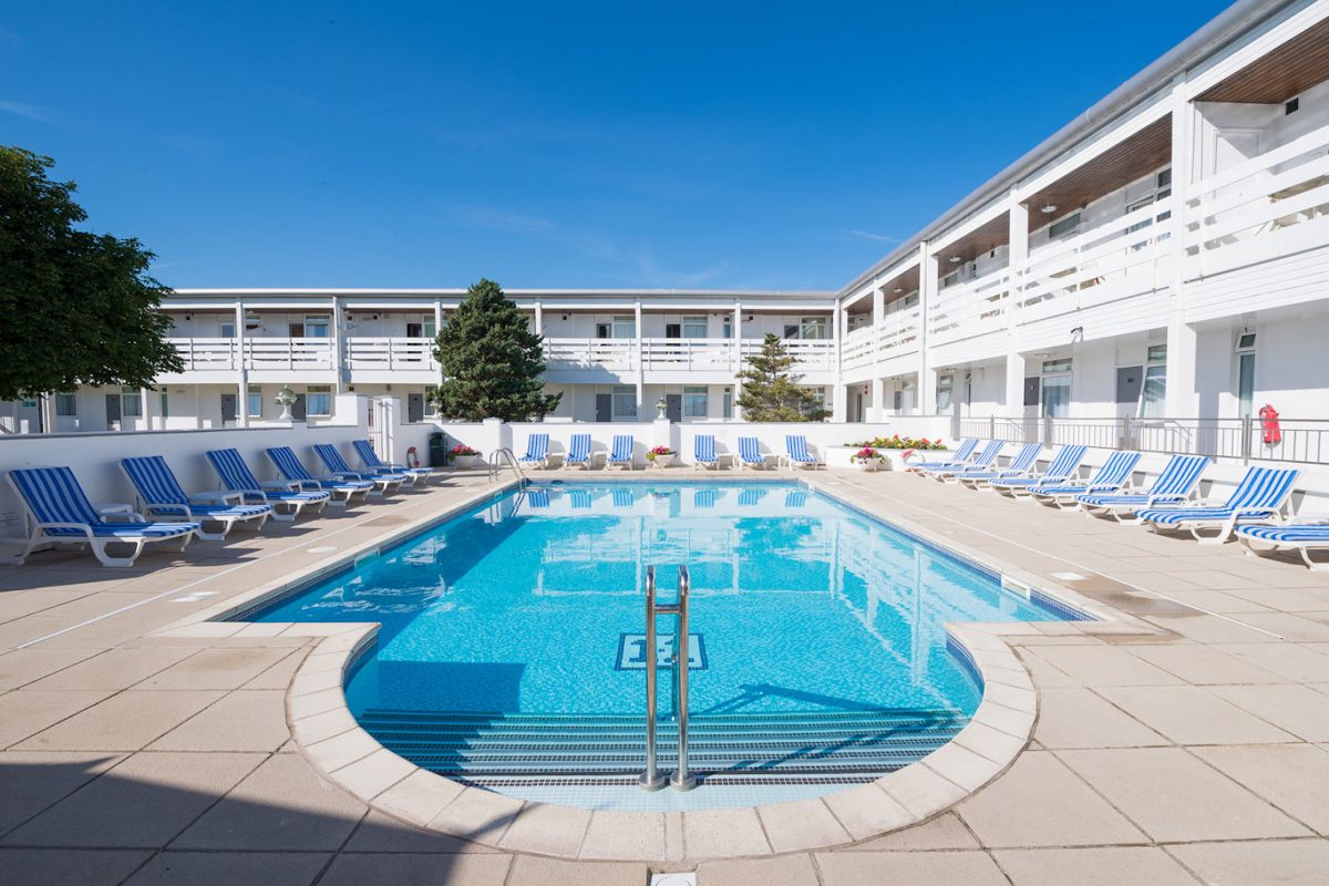 Swim in the outdoor pool surrounded by comfortable sun loungers at The Barnstaple Hotel Devon