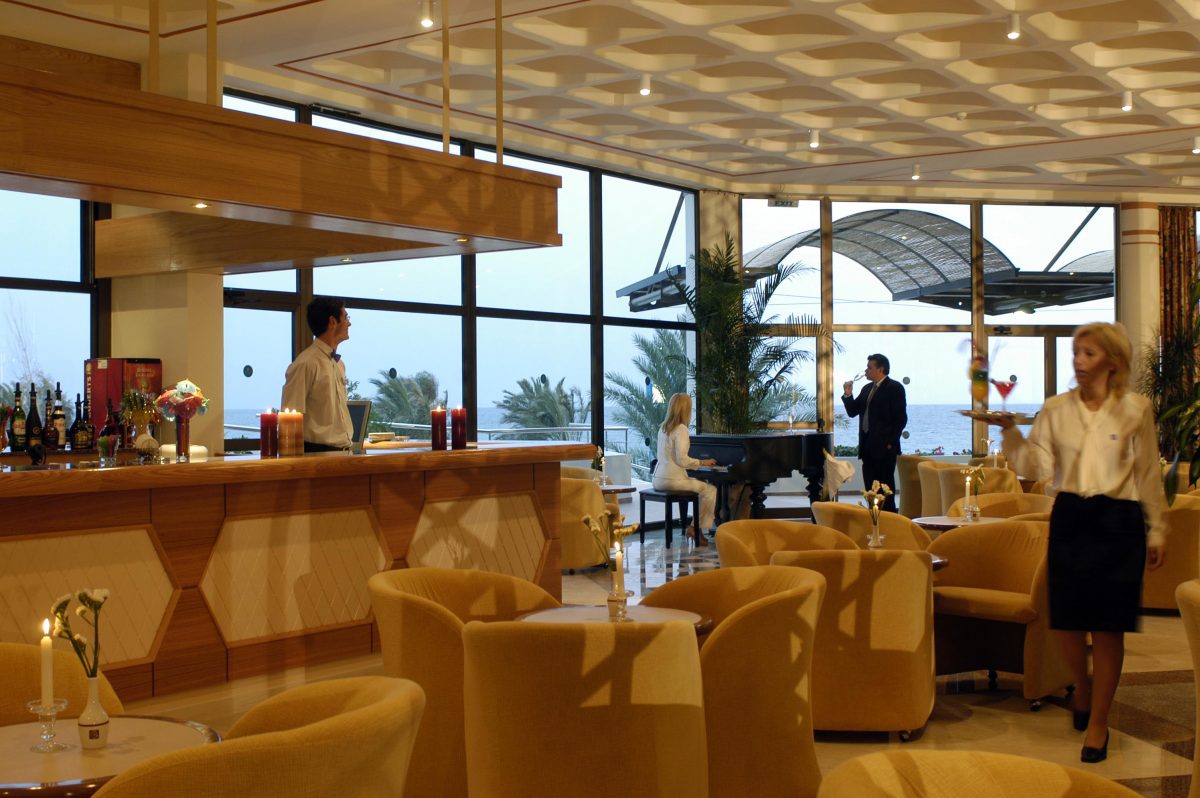 Listen to the pianist in the elegant bar at Constantinou Bros Athena Royal Beach Hotel Paphos