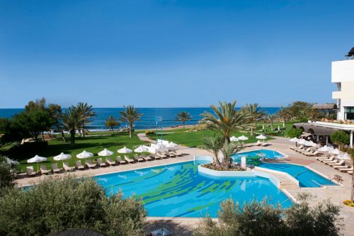 Swim in the large outdoor pool at Constantinou Bros Athena Royal Beach Hotel Paphos