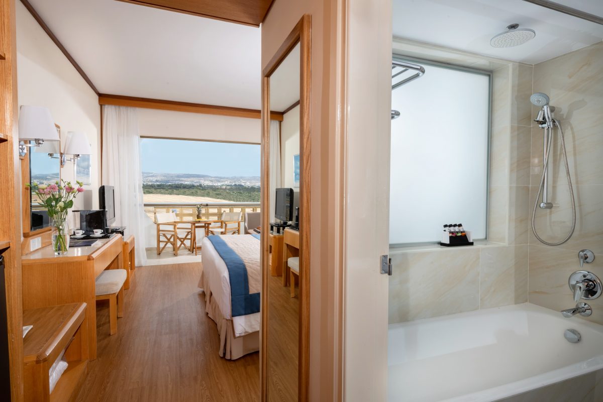Bedroom overlooking the hills at Constantinou Bros Athena Royal Beach hotel Paphos