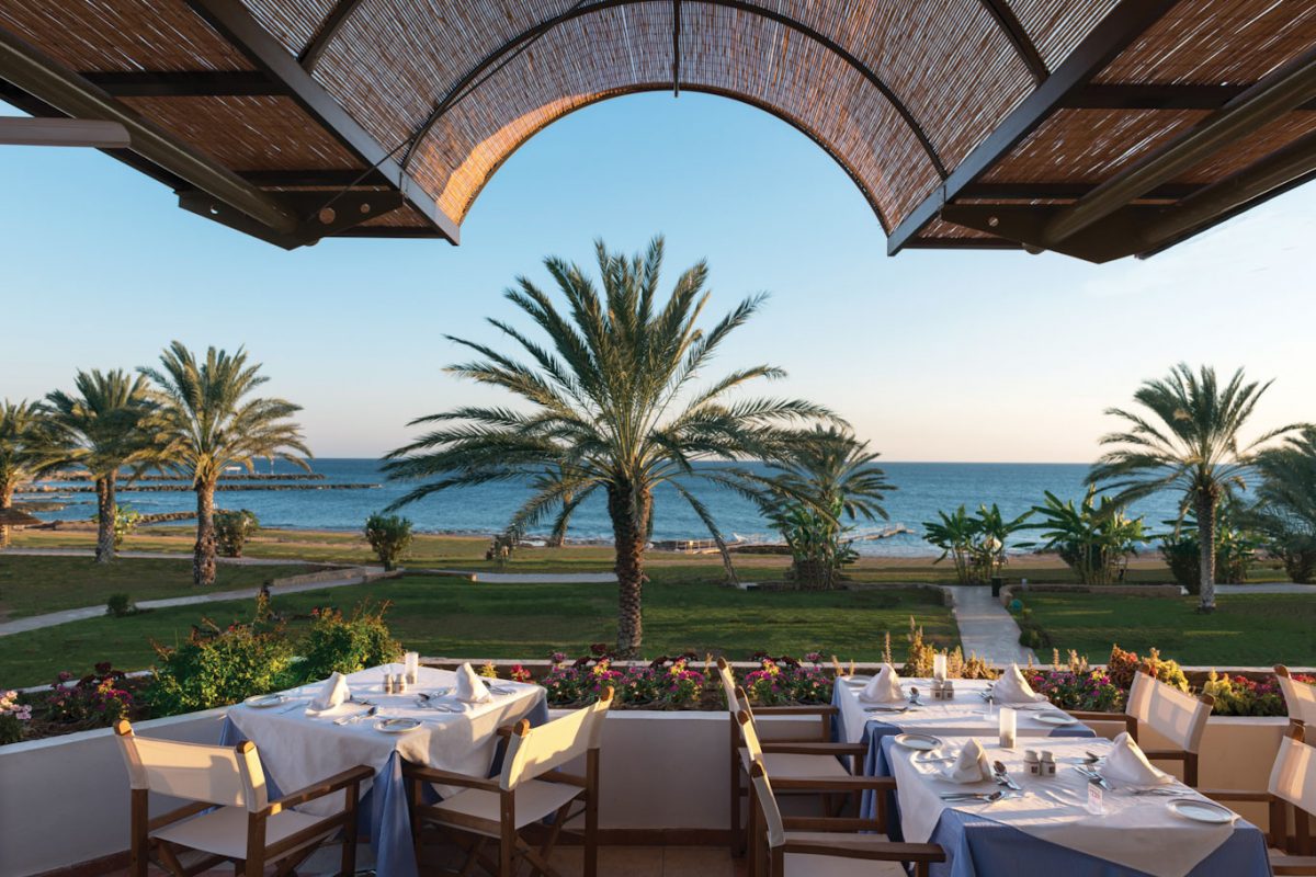 Dine on the terrace overlooking the ocean at Constantinou Bros Athena Royal Beach Hotel Paphos