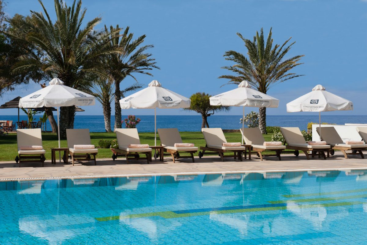 Relax on the comfortable sun loungers at Constantinou Bros Athena Royal Beach Hotel Paphos