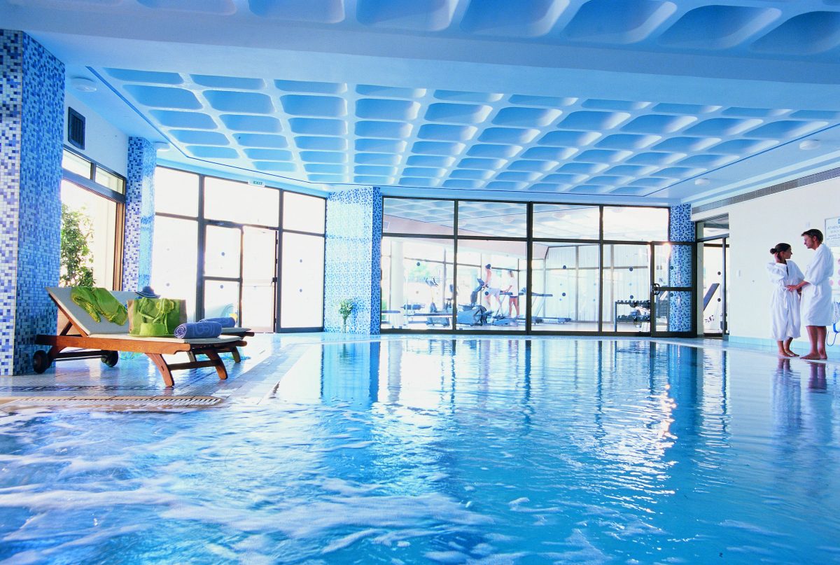 Enjoy the indoor pool and gym at Constantinou Bros Athena Royal Beach hotel Paphos