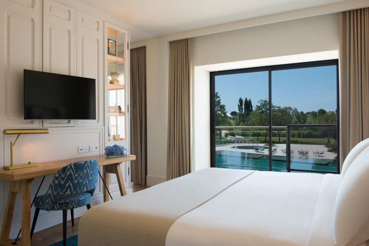 Bedroom overlooking the pool at Hotel Camiral PGA Catalunya Golf Resort, Costa Brava, Spain