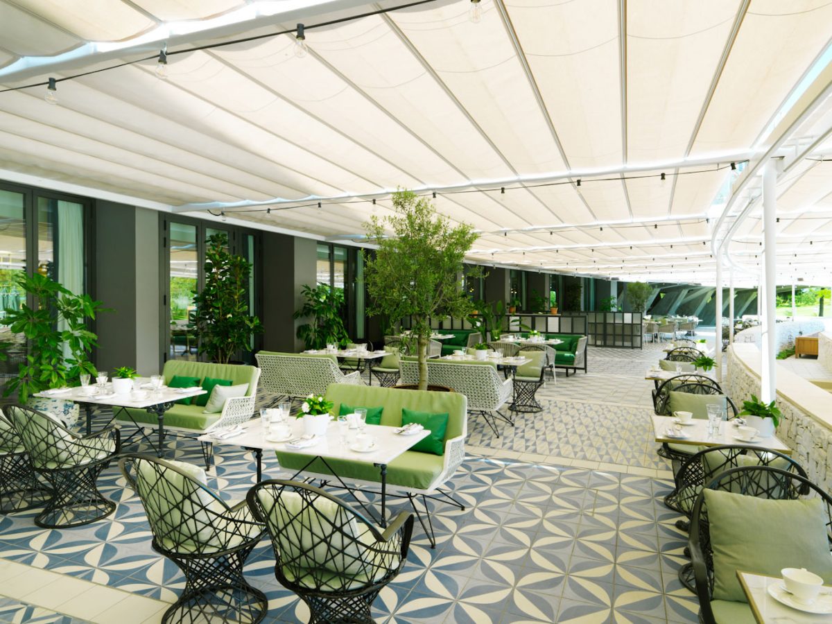 Shaded outdoor dining at Hotel Camiral PGA Catalunya Golf Resort