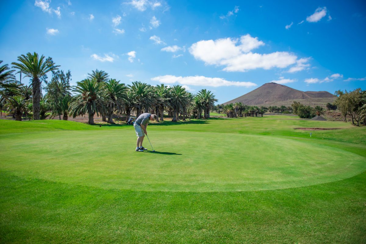 Golfer putting at Lanzarote Golf Club, Canary Islands