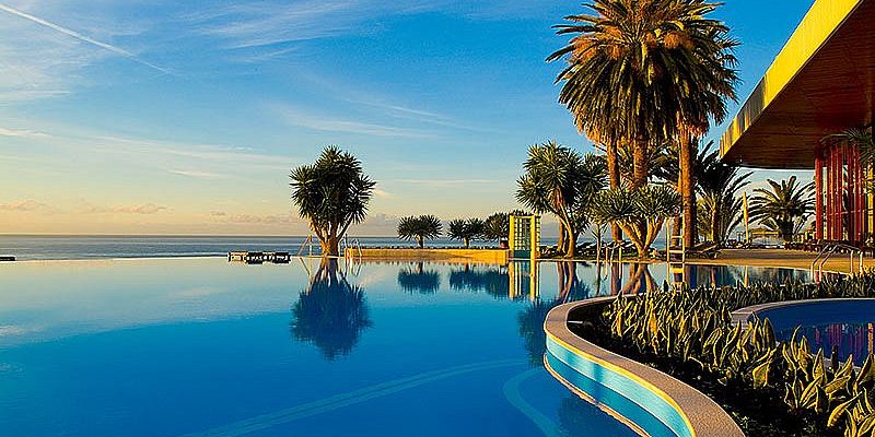 Sunset over the pool at Pestana Casino Park hotel Madeira