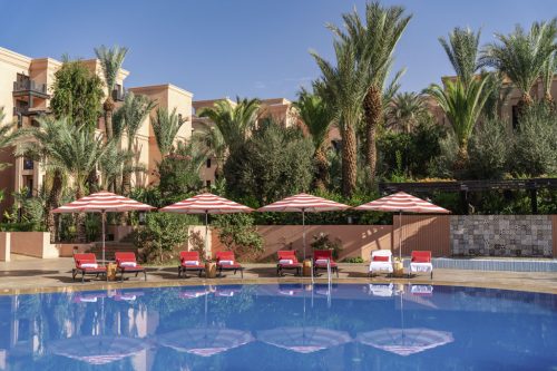 By the pool at Movenpick Hotel Manour Eddahbi, Marrakech, Morocco. Golf Planet Holidays.