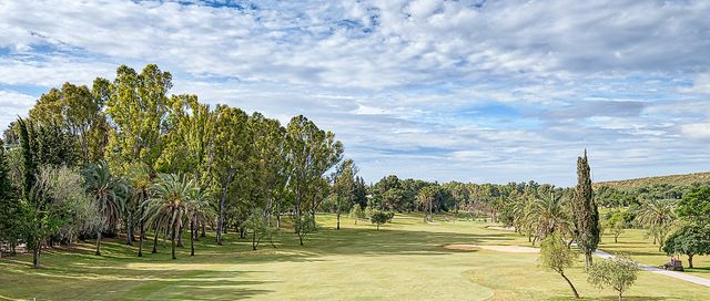 Down the tree-lined fairway at El Paraiso Golf Club, Costa del Sol, Spain. Golf Planet Holidays
