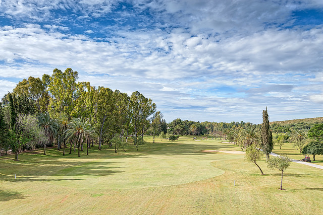 Down the tree-lined fairway at El Paraiso Golf Club, Costa del Sol, Spain. Golf Planet Holidays