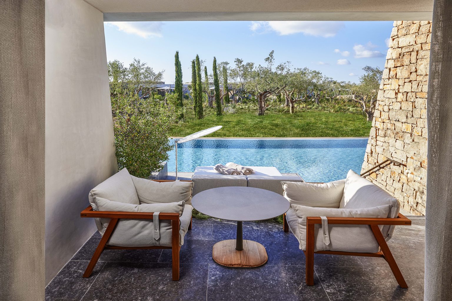 View over an infinity pool at W Costa Navarino, Greece. Golf Planet Holidays.